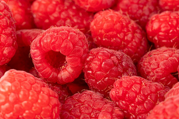 Fresh juicy raspberries bright background. Close-up.