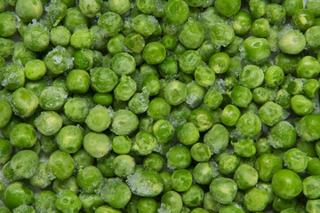 The texture formed by a scattering of green peas with pieces of ice, close-up