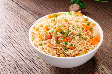 a bowl of instant noodles or pasta Delicious hot soup, Thai, Chinese, Japanese food with chilli and shiitake mushrooms. Carrots arranged on the table, top view