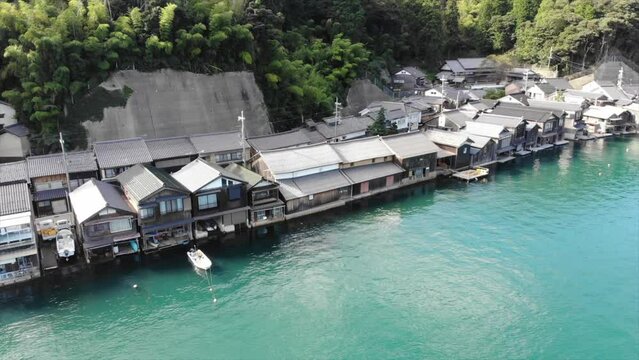 Drone panning shot of wooden fishing houses "Funaya" in Ine town, Yosa District, Kyoto Prefecture, Japan.