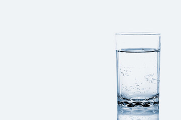 A Glass of soda fizzy of water with bubbles isolated on white background. 