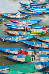 Fototapeta na wymiar Elevated view over blue fishing boats lined up at Lang Co in Vietnam