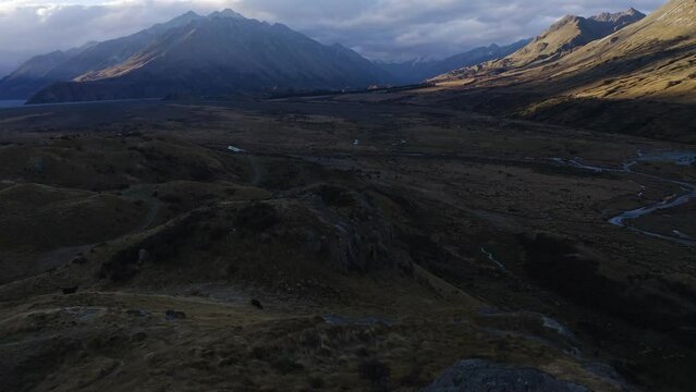 Mount Cook and neighboring mountains during sunset overlooking the valley and flowing rivers seen behind
