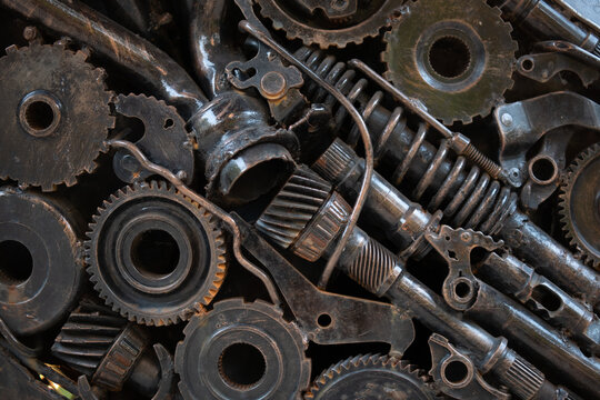texture metal junk nuts bolts wires and other spare parts piled in a mix of metal debris with gears and rust abstract image