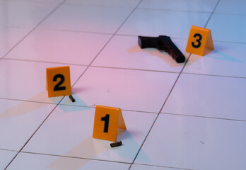 Pieces of evidence tagged by yellow markers,perspective view of shell casings and gun - obrazy, fototapety, plakaty