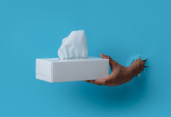 Male hand holding box tissue isolated on a white background
