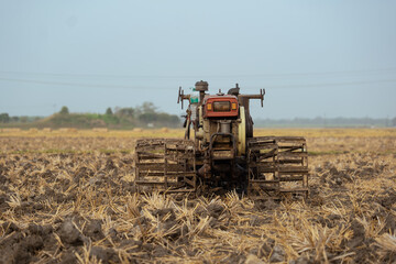 Village agriculture land preparation for cultivation by walking tractor tiller
