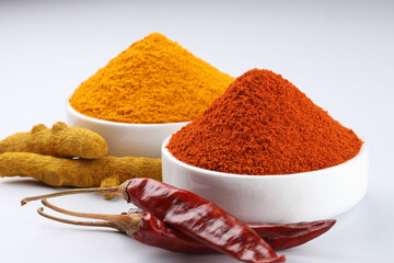 chilli powder and turmeric powder, both used as ingredients in Indian cooking