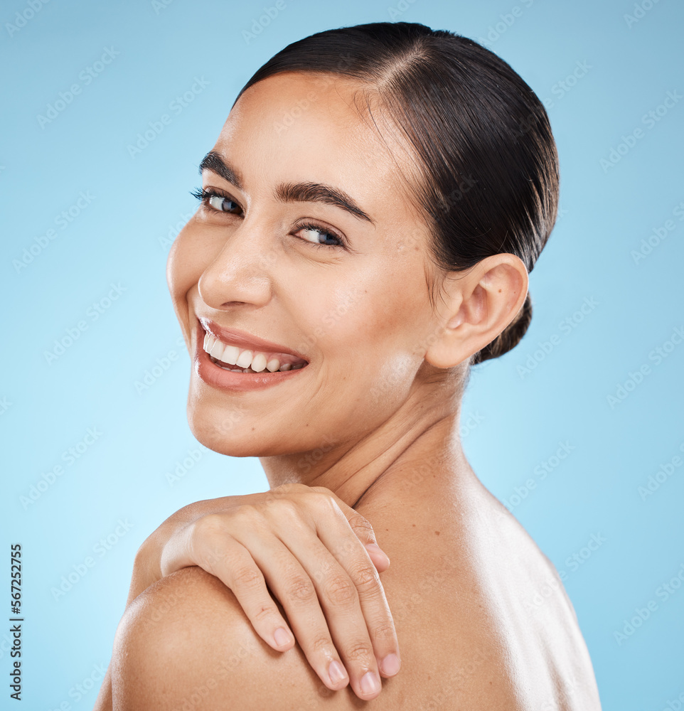 Wall mural Skincare, self care and portrait of a model in a studio for beauty, cosmetic and facial treatment. Cosmetics, happy and woman from Brazil with a healthy face routine isolated by a blue background.