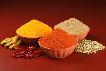 Indian spices and main ingredients of Indian food. Dhania powder or dried coriander seeds, dried red chilly powder, turmeric powder