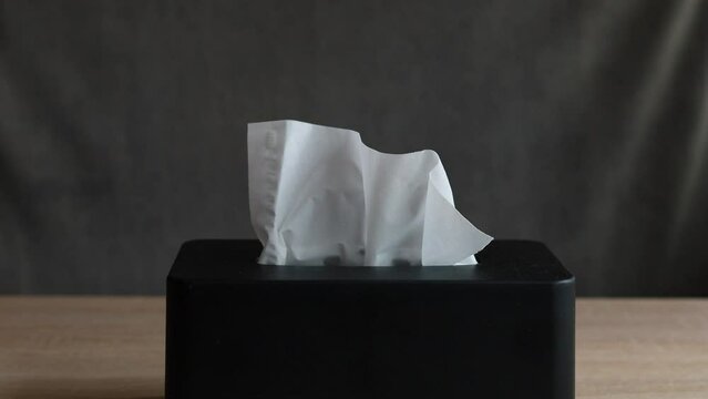 Taking a tissue from the tissue box