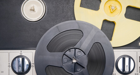 close-up of an old music player, on large reels with magnetic tape