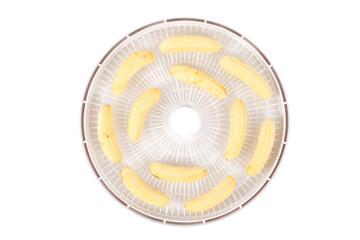 on a white round grate, peeled bananas..for further drying