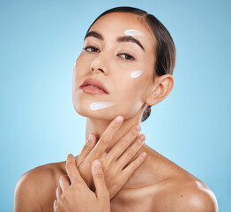 Face portrait, skincare cream and woman in studio isolated on a blue background. Cosmetics,...