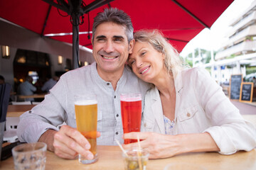 aged couple having a beer in a bar