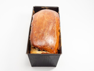 Freshly baked bread with poppy seeds in a mold. Close-up.