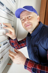 closeup shot of electrician installing fuse in dashboard