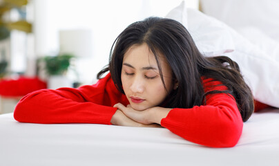 Closeup shot of Millennial Asian young beautiful female model in red casual long sleeve sweater...