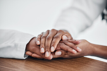 Help, hand and doctor with patient for cancer, bad news or diagnosis during hospital, visit or...
