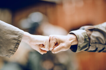 Hands, soldier and fist bump for partnership, deal or agreement in collaboration or trust together. Hand of army people touching fists in support for friendship, community or unity in solidarity