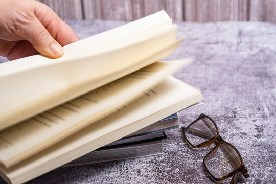 woman's hand turning the pages of a book