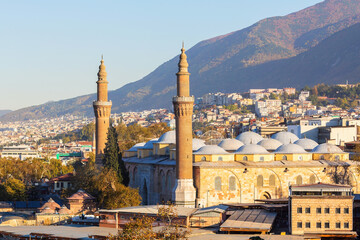 View of Bursa Grand Mosque/Ulu Cami from the hill. Cityscape and the slope of Uludag mountain at...