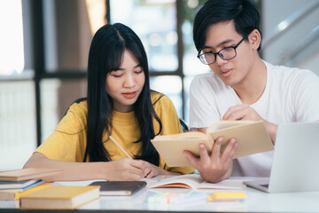 An asian students are reading books and study, Tutoring together.