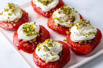 Traditional Turkish style quince dessert. The quince is cooked until soft, sherbet is poured on it, and served with cream and walnuts. It is one of the most popular Turkish desserts.(Ayva Tatlisi)