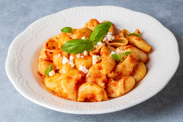 Tomato ravioli pasta or pipe rigate shaped pasta on the cheese