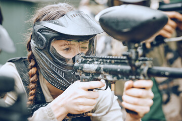 Paintball, gun and woman with helmet aim for shooting ready for game, arena match and battlefield. Extreme sports, military adventure and girl with weapon in camouflage, action and safety gear