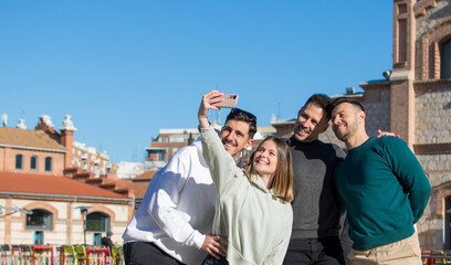 Group of cheerful young friends taking selfie portrait. Happy people looking at the camera smiling. Concept of community, youth lifestyle and friendship 