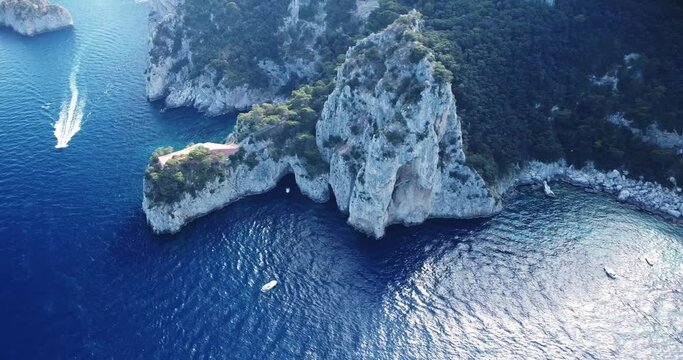 Aerial view of the three Faraglioni rocks off the Capri island. Aerial drone view of the Tyrrhenian sea coast of Capri, Italy. Coastal of azure Tyrrhenian Sea, Capri, island of Gulf of Naples, Italy