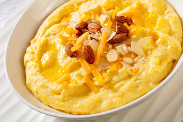 corn grits with butter, vegan cheese, and almonds