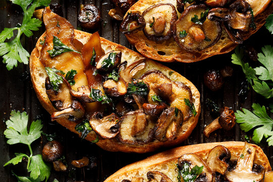 Mushroom grilled sandwich seasoned with parsley on a grill plate,  close up view