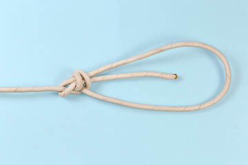 Rope knot double bowline on a blue background