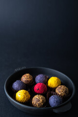 Sweets multi-colored round on a dark concrete background