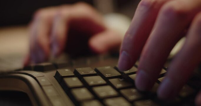 Fingers of male programmer typing text on keyboard of computer. Man writes code for new website working online at home closeup