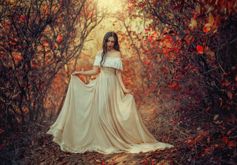 Art photo fantasy woman queen standing in gothic autumn forest, white vintage style dress. Girl...