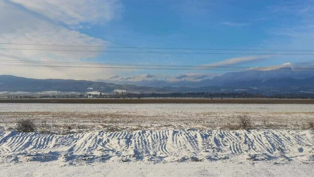 View of the winter landscape from a window of going train