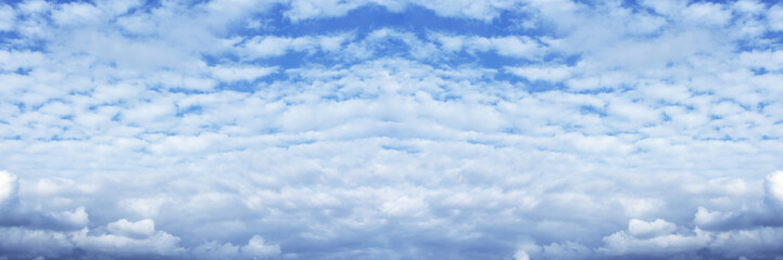 Blue cloudy sky wide background. Heaven cloudscape, clouds. Nature skyscape widescreen wallpaper