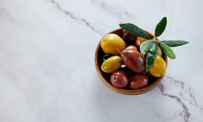 Marinated olives on marble surface