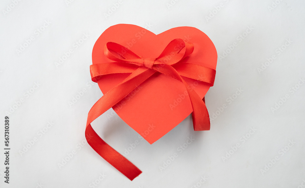 Poster heart gift box with red ribbon tie. love shape design element