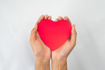 hands holding love paper shape isolated