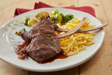 Roasted deer steaks with spaghetti