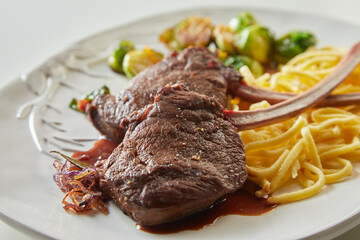 Grilled deer steaks with spaghetti