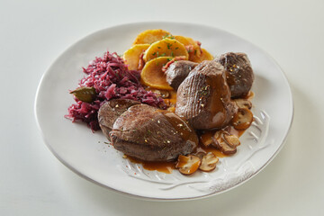 Meat and mushrooms with sauerkraut and potatoes