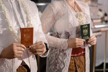 wedding couple in white traditional dress. show the marriage book