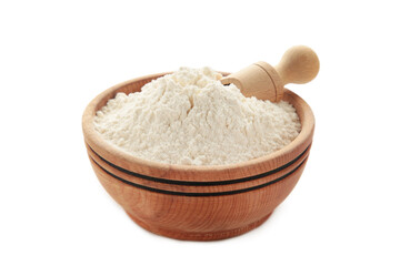 Wooden bowl with flour and flour spoon. Rice or wheat flour isolated on white background.