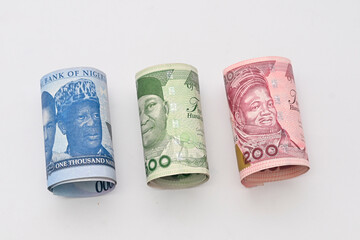 Folded one thousand 1000, Five Hundred 500 and Two  hundred 200 new naira note  bill on a white background with space between them.