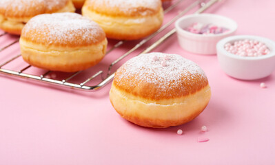 Donuts Doughnuts with Icing Sugar and Sprinkles on Pink Background